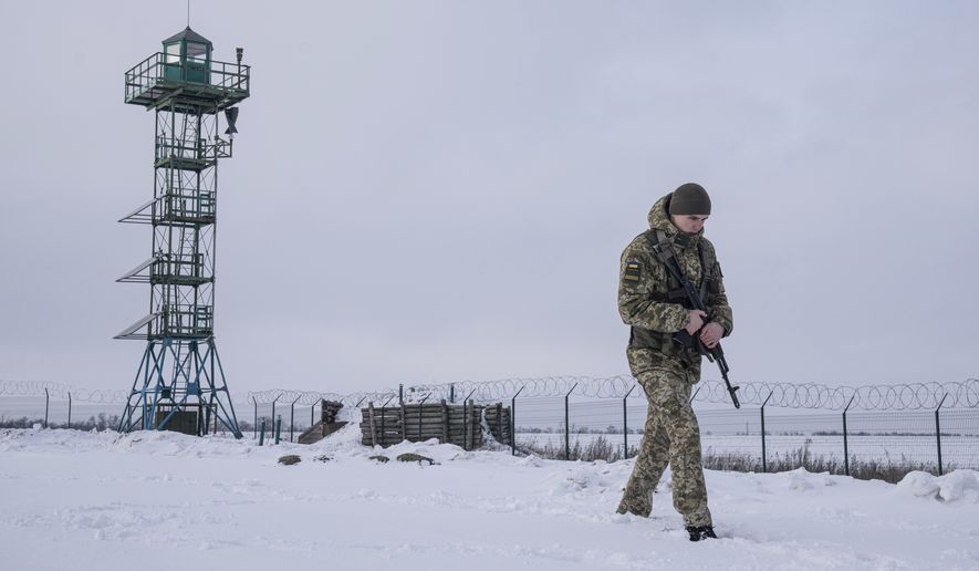 A Ukrainian border guard patrols the border with Russia not far from Hoptivka village, Kharkiv region, Ukraine, Wednesday, Feb. 2, 2022. Russian President Vladimir Putin is accusing the U.S. and its allies of ignoring Russia&#39;s top security demands but says Moscow is willing to talk more to ease tensions over Ukraine. (AP Photo/Evgeniy Maloletka)