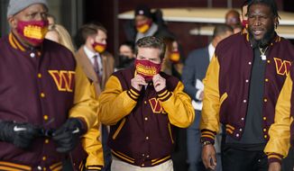 Dan Snyder, center, co-owner and co-CEO of the Washington Commanders, adjusts his mask as he arrives to unveil his NFL football team&#39;s new identity, Wednesday, Feb. 2, 2022, in Landover, Md. The new name comes 18 months after the once-storied franchise dropped its old moniker following decades of criticism that it was offensive to Native Americans. (AP Photo/Patrick Semansky) ** FILE**