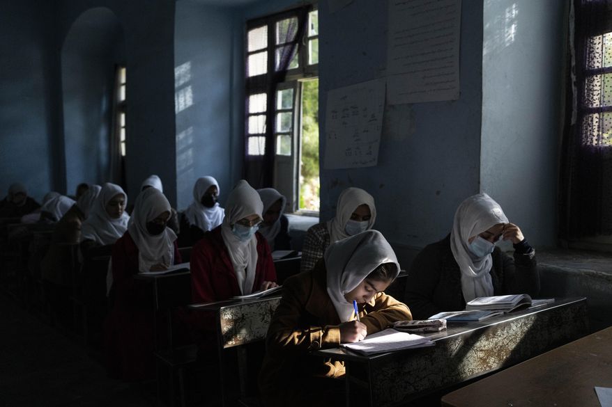 FILE - Afghan girls participate a lesson at Tajrobawai Girls High School, in Herat, Afghanistan, Thursday, Nov. 25, 2021. The Taliban say they have reopened public universities for women students in six of Afghanistan’s 34 provinces, Wednesday, Feb. 2, 2022, a move marking a major concession to international demands by the country’s new rulers. Women have been banned from many jobs outside the health and teaching sector since the Taliban takeover, and girls have not been able to go to school after grade six. (AP Photo/Petros Giannakouris, File)