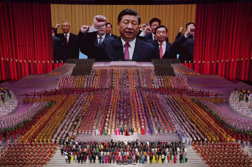 Chinese President Xi Jinping is seen leading other top officials pledging their vows to the party on-screen during a gala show ahead of the 100th anniversary of the founding of the Chinese Communist Party in Beijing, June 28, 2021. Chinese government instructions posted on social media reveal that Chinese Communist Party propaganda organs have been ordered to avoid criticizing Russia&#39;s invasion of Ukraine. (AP Photo/Ng Han Guan, File)