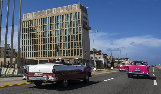 Tourists ride classic convertible cars on the Malecon beside the U.S. Embassy in Havana, Cuba, on Oct. 3, 2017. A panel of intelligence experts hasn&#x27;t identified a single culprit for apparent brain injuries reported by U.S. personnel that have been linked to so-called &amp;quot;Havana syndrome. But officials who briefed reporters Wednesday say several potential causes remain plausible, including the use of devices that emit beams of directed energy. (AP Photo/Desmond Boylan, File)