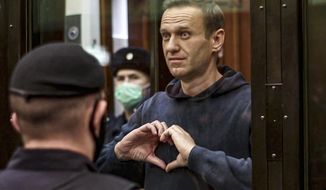 In this image from video provided by the Moscow City Court, opposition leader Alexei Navalny makes a heart symbol standing in a cage during a hearing to convert the suspended sentence of Navalny from the 2014 criminal conviction into a real prison term, in Moscow, Russia, on Wednesday, Feb. 3, 2021, The prison sentence on the leading Kremlin critic was a severe blow to Russia&#39;s opposition — and then the situation got worse. (Moscow City Court via AP, File)