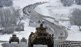 A convoy of Russian armored vehicles moves along a highway in Crimea, Jan. 18, 2022. Russia has concentrated an estimated 100,000 troops with tanks and other heavy weapons near Ukraine in what the West fears could be a prelude to an invasion. (AP Photo, File)
