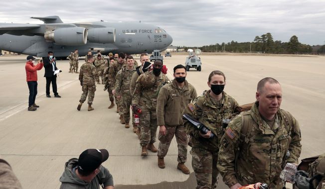 U.S. Army soldiers from the 18th Airborne Division prepare to board a C-17 aircraft as they deploy to Europe from Fort Bragg, N.C., on Thursday, Feb. 3, 2022. (AP Photo/Chris Seward) **FILE**
