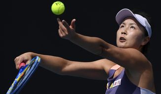 FILE - China&#39;s Peng Shuai serves to Japan&#39;s Nao Hibino during their first round singles match at the Australian Open tennis championship in Melbourne, Australia, on Jan. 21, 2020. The controversy surrounding Chinese tennis star Peng Shuai’s accusations of sexual assault against a former top politician continues to cast a shadow of the Beijing Winter Olympic Games that officially begin on Friday, Feb. 4. 2022. Peng disappeared from public view in November, 2021, after accusing former Communist Party official Zhang Gaoli of sexual assault. (AP Photo/Andy Brownbill, File)