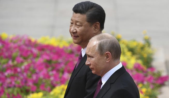 Russia&#x27;s President Vladimir Putin, right, reviews a military honor guard with Chinese President Xi Jinping during a welcoming ceremony outside the Great Hall of the People in Beijing, June 8, 2018. Russian President Putin on Friday, Feb. 4, 2022, arrived in Beijing for the opening of the Winter Olympic Games and talks with his Chinese counterpart Xi Jinping, as the two leaders look to project themselves as a counterweight to the U.S. and its allies. (Greg Baker/Pool Photo via AP) **FILE**