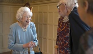 Britain&#39;s Queen Elizabeth II, left, talks to members of the West Norfolk Befriending Society during a reception to celebrate the start of the Platinum Jubilee, at Sandringham House, her Norfolk residence, in Sandringham, England, Saturday, Feb. 5, 2022. The Queen has hosted a reception for members of the local community and volunteer groups at Sandringham House on the eve of Accession Day, the seventieth anniversary of her reign. (Joe Giddens/Pool Photo via AP)