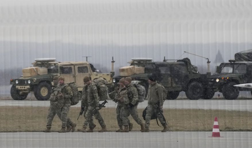 U.S. Army troops of the 82nd Airborne Division unloading vehicles from a transport plane after arriving from Fort Bragg at the Rzeszow-Jasionka airport in southeastern Poland, on Sunday, Feb. 6, 2022. Additional U.S. troops are arriving in Poland after President Joe Biden ordered the deployment of 1,700 soldiers here amid fears of a Russian invasion of Ukraine. Some 4,000 U.S. troops have been stationed in Poland since 2017. (AP Photo/Czarek Sokolowski)