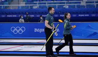 Australia&#x27;s Tahli Gill and Dean Hewitt, compete during the mixed doubles curling match against Switzerland, at the 2022 Winter Olympics, Sunday, Feb. 6, 2022, in Beijing. (AP Photo/Nariman El-Mofty)