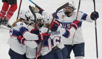 United States players celebrate a goal scored against Switzerland during a preliminary round women&#39;s hockey game at the 2022 Winter Olympics, Sunday, Feb. 6, 2022, in Beijing. (AP Photo/Petr David Josek)