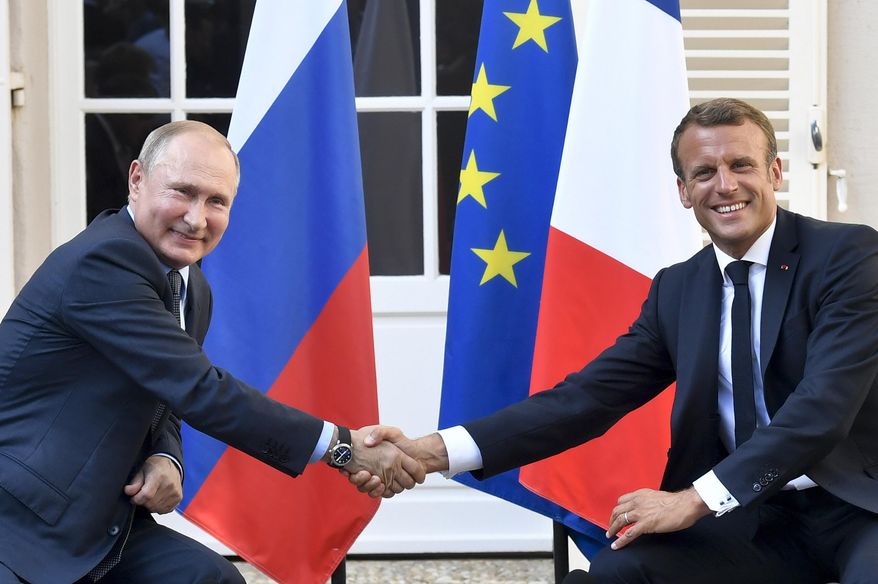 French President Emmanuel Macron, right, shakes hands with Russian President Vladimir Putin after their meeting at the fort of Bregancon in Bormes-les-Mimosas, southern France, on Aug. 19, 2019. Rarely in recent years has the Kremlin been so popular with European visitors. French President Emmanuel Macron arrives Monday, Feb. 7, 2022. The Hungarian prime minister visited last week. And in days to come, the German chancellor will be there, too. (Gerard Julien, Pool via AP, File)