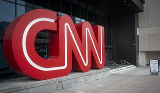 The CNN logo is displayed at the entrance to the CNN Center in Atlanta on Wednesday, Feb. 2, 2022. CNN’s Jeff Zucker’s abrupt exit this week after failing to disclose a workplace relationship is yet another reminder that companies should have a firm policy in place when workplace relationships arise, even in the C-Suite. (AP Photo/Ron Harris)