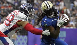 NFC running back Alvin Kamara (41), of the New Orleans Saints, rushes against the AFC linebacker Harold Landry III, of the Tennessee Titans during the Pro Bowl NFL football game, Sunday, Feb. 6, 2022, in Las Vegas. (AP Photo/David Becker) **FILE**