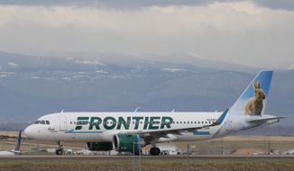 A Frontier Airlines jetliner taxis to a runway to take off from Denver International Airport Thursday, April 23, 2020, in Denver. Frontier Airlines&#39; parent company is buying Spirit Airlines in a $2.9 billion cash-and-stock deal that will allow the combined airline to be more competitive against its larger rivals. (AP Photo/David Zalubowski, File)