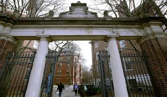 A gate opens to the Harvard University campus, on Dec. 13, 2018, in Cambridge, Mass. Three Harvard University graduate students said in a federal lawsuit filed Tuesday, Feb. 8, 2022, that the Ivy League school for years ignored complaints about sexual harassment by a renowned professor and allowed him to intimidate students by threatening to hinder their careers. (AP Photo/Charles Krupa, File)  **FILE**