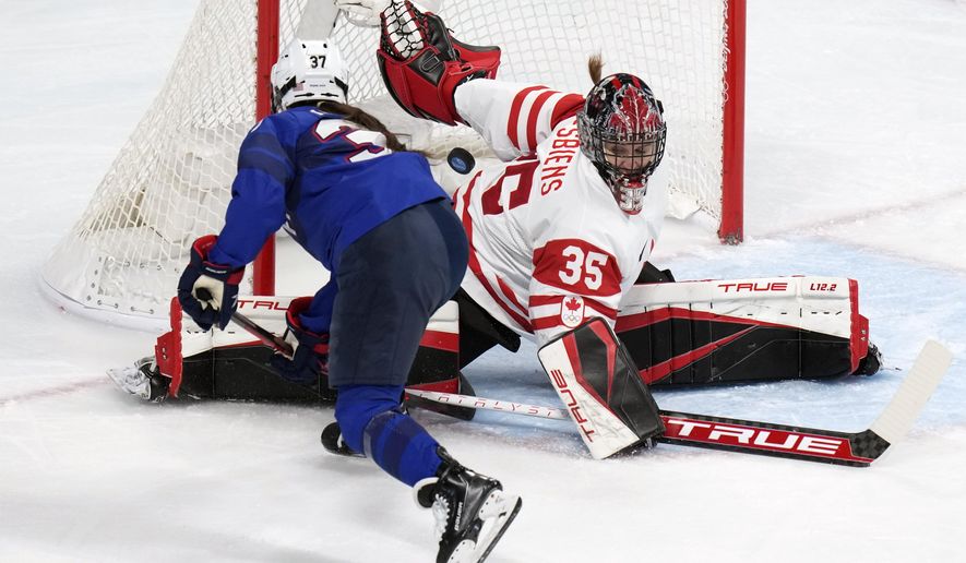 Canada goalkeeper Ann-Renee Desbiens (35) blocks a shot by United States&#39; Abbey Murphy (37) during a preliminary round women&#39;s hockey game at the 2022 Winter Olympics, Tuesday, Feb. 8, 2022, in Beijing. (AP Photo/Petr David Josek)