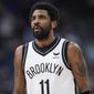 Brooklyn Nets guard Kyrie Irving checks the scoreboard as time runs out in the second half of an NBA basketball game against the Denver Nuggets Sunday, Feb. 6, 2022, in Denver. (AP Photo/David Zalubowski)