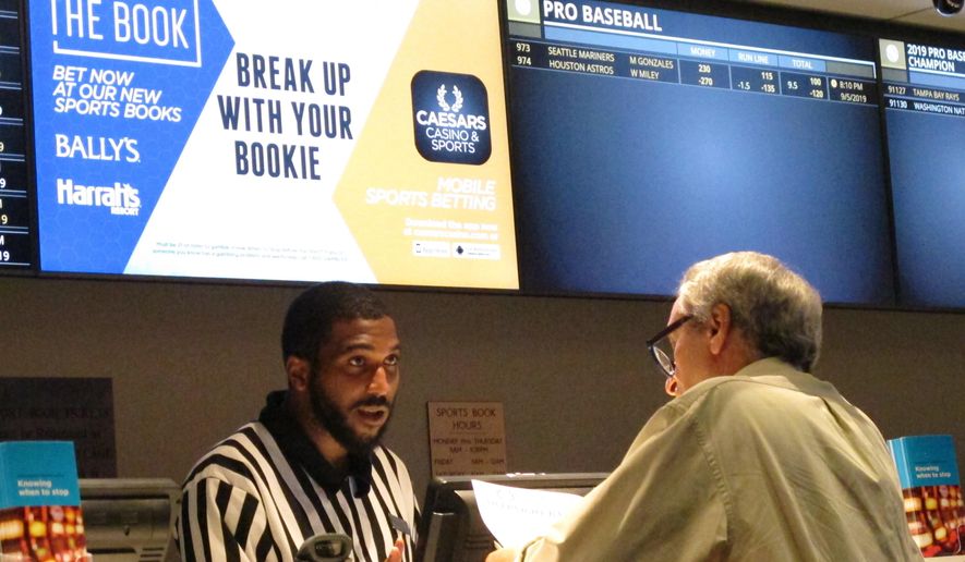 A gambler makes a sports bet at Bally&#x27;s casino in Atlantic City N.J., Sept. 5, 2019. A record 31.5 million Americans plan to bet on this year&#x27;s Super Bowl, according to the gambling industry&#x27;s national trade group. The American Gaming Association on Tuesday, Feb. 8, 2022, released its annual predictions for wagering on pro football&#x27;s championship game, forecasting that over $7.6 billion will be bet legally and otherwise. (AP Photo/Wayne Parry) **FILE**