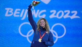 Lindsey Jacobellis acknowledges the crowd during a medal ceremony for the women&#39;s snowboard cross finals competition at the 2022 Winter Olympics, Wednesday, Feb. 9, 2022, in Zhangjiakou, China. (AP Photo/Frank Augstein)