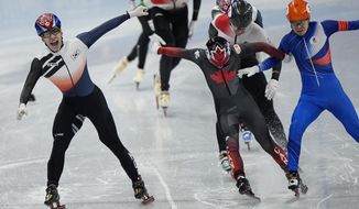 Hwang Dae-heon, left, of South Korea, reacts after winning his men&#39;s 1500-meters final during the short track speedskating competition at the 2022 Winter Olympics, Wednesday, Feb. 9, 2022, in Beijing.(AP Photo/David J. Phillip)