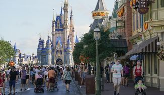 Guests stroll along Main Street at the Magic Kingdom theme park at Walt Disney World on Aug. 30, 2021, in Lake Buena Vista, Fla. A theme-park comeback continued to boost Disney&#39;s results in the most recent quarter. The company also added more subscribers to its Disney+ streaming service than analysts expected. (AP Photo/John Raoux, File)