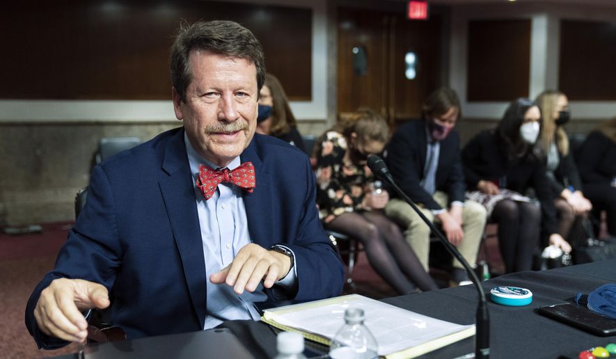 Dr. Robert Califf gathers his documents as the Senate Committee on Health, Education, Labor and Pension adjourns a hearing on the nomination of Dr. Califf to be commissioner of the Food and Drug Administration on Capitol Hill in Washington, on Dec. 14, 2021. (AP Photo/Manuel Balce Ceneta, File)