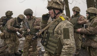 Ukrainian servicemen check their equipment during an exercise in a Joint Forces Operation controlled area in the Donetsk region, eastern Ukraine, Thursday, Feb. 10, 2022. A peace agreement for the separatist conflict in eastern Ukraine that has never quite ended is back in the spotlight amid a Russian military buildup near the country&#39;s borders and rising tensions about whether Moscow will invade. (AP Photo/Vadim Ghirda)