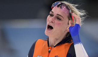 Irene Schouten of the Netherlands reacts after wining the gold medal and setting an Olympic record in the women&#39;s speedskating 5,000-meter race at the 2022 Winter Olympics, Thursday, Feb. 10, 2022, in Beijing. (AP Photo/Sue Ogrocki)