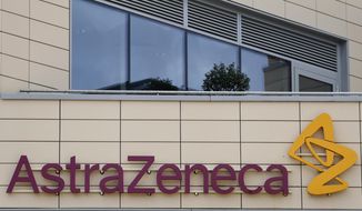 FILE - A general view of AstraZeneca offices and the corporate logo in Cambridge, England, Saturday, July 18, 2020. AstraZeneca has recorded a big jump in revenue as it begins to take a profit from its coronavirus vaccine for the first time. The company recorded full-year revenues of $37.4 billion, an increase of 38% from the year before at constant exchange rates. Part of the boost came from $4 billion in sales of its COVID-19 vaccine, developed with the University of Oxford. Despite rising revenue, AstraZeneca reported a pre-tax loss of $265 million due to costs from its purchase of U.S. drug company Alexion Pharmaceuticals and new drug research. (AP Photo/Alastair Grant, File)