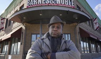 FILE - In this Jan. 21, 2021, file photo, Andre Brady poses for a photo outside the Barnes &amp;amp; Noble in Youngstown, Ohio. The fired bookstore employee continued the yearslong battle for his job in appellate court on Wednesday, Aug. 18, 2021. Brady lost his union job as a sales manager at the Youngstown State University bookstore in 2016. His employer and other public universities were under pressure to reduce costs and pass the savings along to students (AP Photo/Tony Dejak, File)