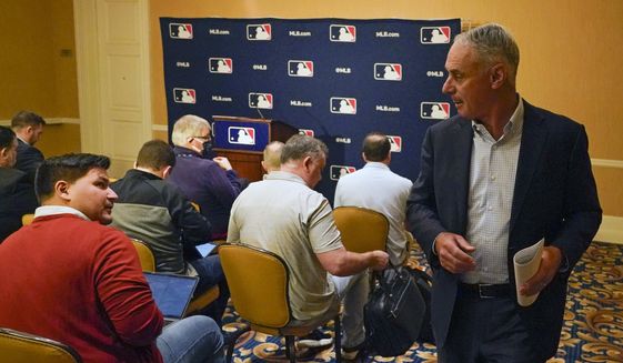 Major League Baseball commissioner Rob Manfred leaves a news conference at MLB baseball owners meetings, Thursday, Feb. 10, 2022, in Orlando, Fla. Manfred says spring training remains on hold because of a management lockout and his goal is to reach a labor contract that allows opening day as scheduled on March 31. (AP Photo/John Raoux) **FILE**