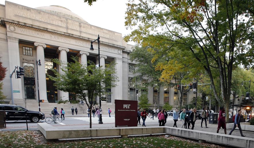 In this Oct. 21, 2015, file photo, students walk on the Massachusetts Institute of Technology campus in Cambridge, Mass. (AP Photo/Michael Dwyer, File)