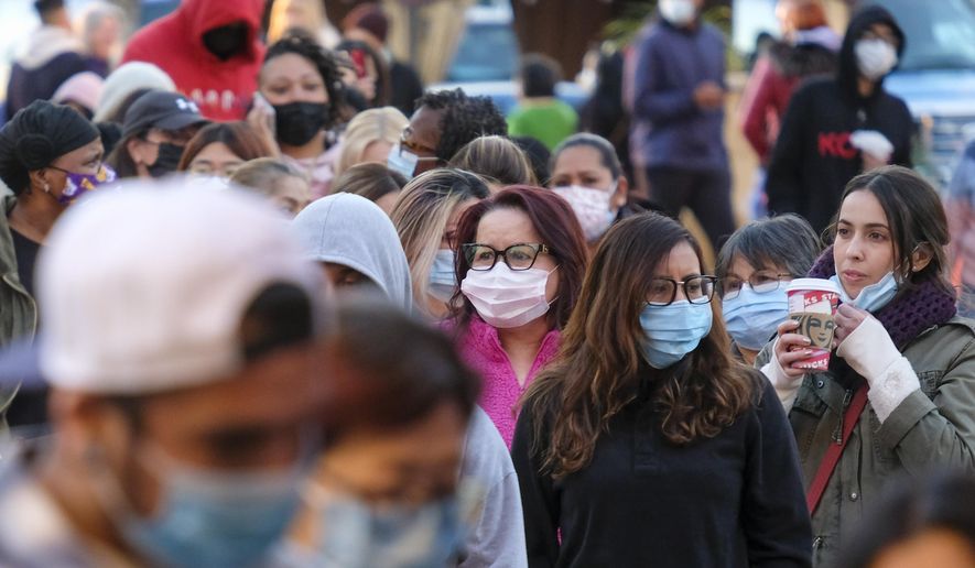 Black Friday shoppers wearing face masks wait in line to enter a store at the Citadel Outlets in Commerce, Calif., Friday, Nov. 26, 2021. (AP Photo/Ringo H.W. Chiu, File)