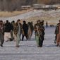 Taliban fighters walk at the frozen Qargha Lake, near Kabul, Afghanistan, in Kabul, Afghanistan, Friday, Feb. 11, 2022. The Taliban have detained two foreign journalists on assignment with the U.N. refugee agency and a number of its Afghan staff working in the country&#39;s capital, UNHCR said Friday. (AP Photo/Hussein Malla)