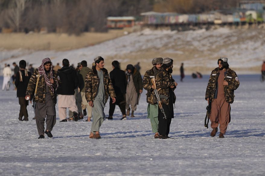 Taliban fighters walk at the frozen Qargha Lake, near Kabul, Afghanistan, in Kabul, Afghanistan, Friday, Feb. 11, 2022. The Taliban have detained two foreign journalists on assignment with the U.N. refugee agency and a number of its Afghan staff working in the country&#39;s capital, UNHCR said Friday. (AP Photo/Hussein Malla)