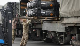Ukrainian servicemen load Javelin anti-tank missiles, delivered as part of the United States of America&#39;s security assistance to Ukraine, into military trucks at the Boryspil airport, outside Kyiv, Ukraine, Friday, Feb. 11, 2022. The Polish military, meanwhile, has made an urgent request for 1,000 U.S. Army Javelin anti-tank missiles earlier this month but Pentagon red tape is delaying efforts to get large numbers of the missiles to the Ukrainian military. (AP Photo/Efrem Lukatsky)