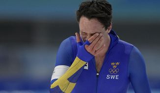 Nils van der Poel of Sweden reacts after breaking his own world record in the men&#39;s speedskating 10,000-meter race at the 2022 Winter Olympics, Friday, Feb. 11, 2022, in Beijing. (AP Photo/Ashley Landis)