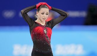Kamila Valieva, 15, of the Russian Olympic Committee, reacts after the women&#39;s team free skate program during the figure skating competition at the 2022 Winter Olympics, Monday, Feb. 7, 2022, in Beijing. The 2022 Games&#39; first major scandal has managed to involve the 15-year-old figure skater who has tested positive for using a banned heart medication that may cost her Russia-but-not-really-Russia team a gold medal in team competition. Kamila Valieva continues to train even as her final disposition is considered, and she may yet compete in the women&#39;s individual competition, in which she is favored. (AP Photo/Natacha Pisarenko)