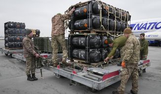 In this Feb. 11, 2022, file photo, Ukrainian servicemen unpack Javelin anti-tank missiles, delivered as part of the United States of America&#39;s security assistance to Ukraine, at the Boryspil airport. On April 12, 2022, the Pentagon said it is considering enhanced artillery support to Kyiv, enabling Ukrainian forces to take on invading Russians at much greater distances than weapons like the Javelin. (AP Photo/Efrem Lukatsky)  **FILE**