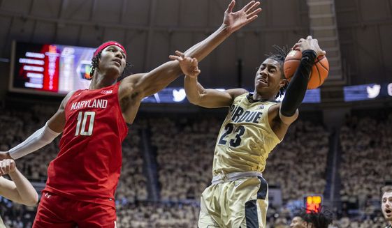 Purdue guard Jaden Ivey (23) reacts as he catches a rebound while Maryland forward Julian Reese (10) defends during the first half of an NCAA college basketball game, Sunday, Feb. 13, 2022, in West Lafayette, Ind. (AP Photo/Doug McSchooler)