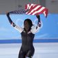 Erin Jackson of the United States hoists an American flag after winning the gold medal in the speedskating women&#39;s 500-meter race at the 2022 Winter Olympics, Sunday, Feb. 13, 2022, in Beijing. (AP Photo/Sue Ogrocki)