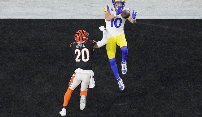 Los Angeles Rams wide receiver Cooper Kupp (10) grabs a touchdown pass as Cincinnati Bengals cornerback Eli Apple (20) is late with tackle during the second half of the NFL Super Bowl 56 football game, Sunday, Feb. 13, 2022, in Inglewood, Calif. (AP Photo/Matt Rourke)