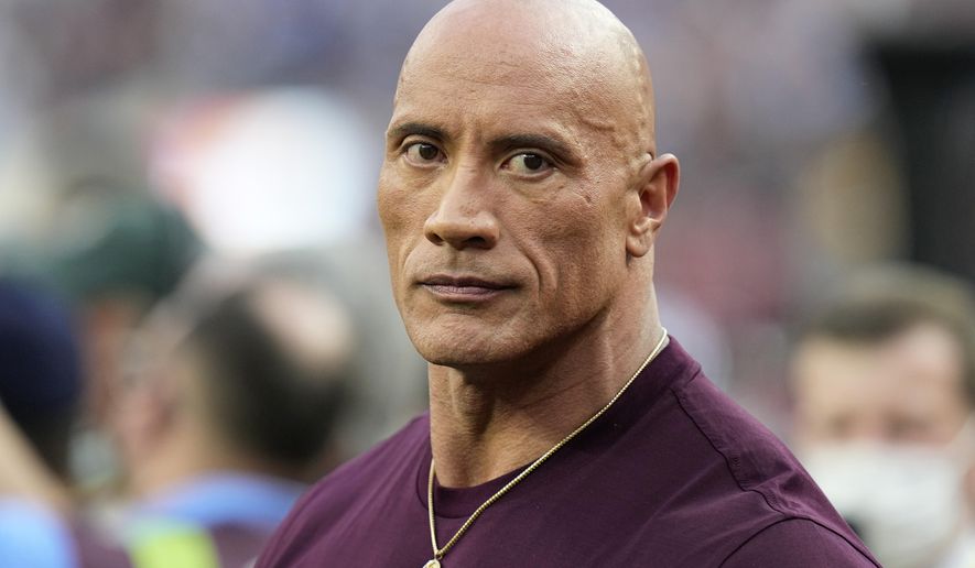 Dwayne &amp;quot;The Rock&amp;quot; Johnson stands on the field before the NFL Super Bowl 56 football game between the Los Angeles Rams and the Cincinnati Bengals, Sunday, Feb. 13, 2022, in Inglewood, Calif. (AP Photo/Chris O&#x27;Meara)
