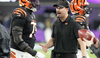 Cincinnati Bengals head coach Zac Taylor talks with offensive tackle Isaiah Prince (75) during the second half of the NFL Super Bowl 56 football game against the Los Angeles Rams Sunday, Feb. 13, 2022, in Inglewood, Calif. (AP Photo/Chris O&#39;Meara)