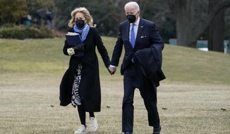 President Joe Biden and first lady Jill Biden walk on the South Lawn of the White House after stepping off Marine One, Monday, Feb. 14, 2022, in Washington. The Bidens are returning to Washington after spending the weekend at Camp David. (AP Photo/Patrick Semansky)