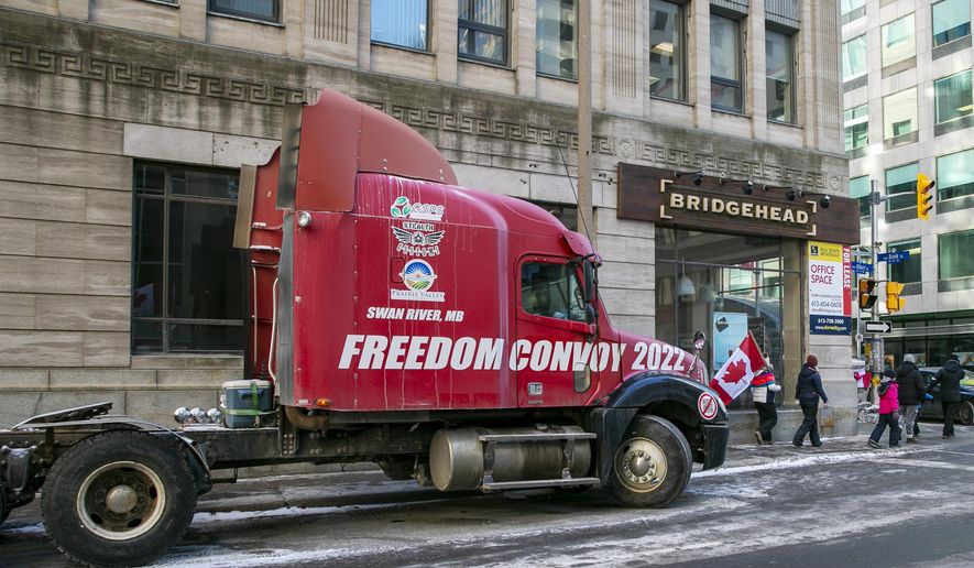 The words &quot;Freedom Convoy 2022: are visible on a truck that is part of a demonstration against COVID-19 restrictions in Ottawa, Ontario, Canada, on Sunday, Feb. 13, 2022. (AP Photo/Ted Shaffrey)