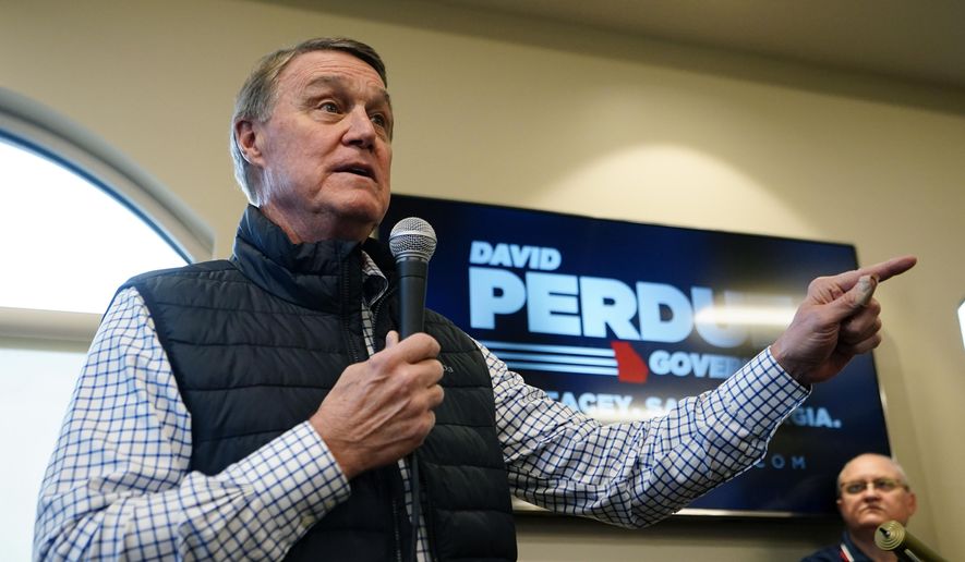 Republican candidate for Georgia governor former Sen. David Perdue arrives to speak at a campaign stop at the Covington airport Wednesday, Feb. 2, 2022, in Covington, Ga. Perdue is attacking incumbent Gov. Brian Kemp for not doing enough to stop school districts from requiring students to wear masks because of COVID-19. (AP Photo/John Bazemore, File)