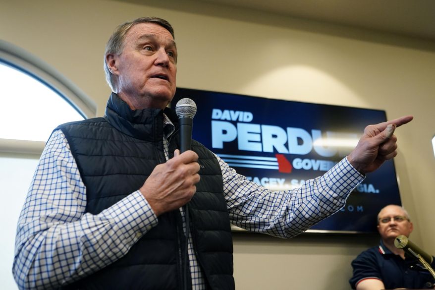 Republican candidate for Georgia governor former Sen. David Perdue arrives to speak at a campaign stop at the Covington airport Wednesday, Feb. 2, 2022, in Covington, Ga. Perdue is attacking incumbent Gov. Brian Kemp for not doing enough to stop school districts from requiring students to wear masks because of COVID-19. (AP Photo/John Bazemore, File)