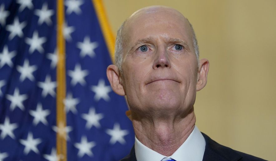 FILE - Sen. Rick Scott, R-Fla., talks with reporters on Capitol Hill in Washington, on Jan. 20, 2022. He was talking about President Joe Biden&#x27;s first year as president. Two widely supported bills are encountering delays in the Senate. The House easily approved the measures last week with broad bipartisan support. (AP Photo/Susan Walsh, File)