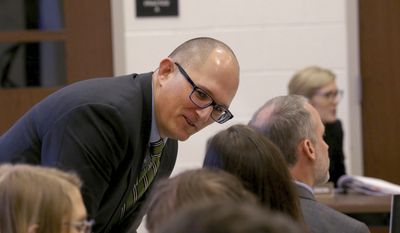 In this Thursday Dec. 6, 2018 photo, high school teacher Peter Vlaming chats at a West Point School Board hearing in West Point, Va. The board voted unanimously to dismiss Vlaming, a high school teacher who refused to use a transgender student&#39;s new pronouns. (Shelby Lum/Richmond Times-Dispatch via AP)